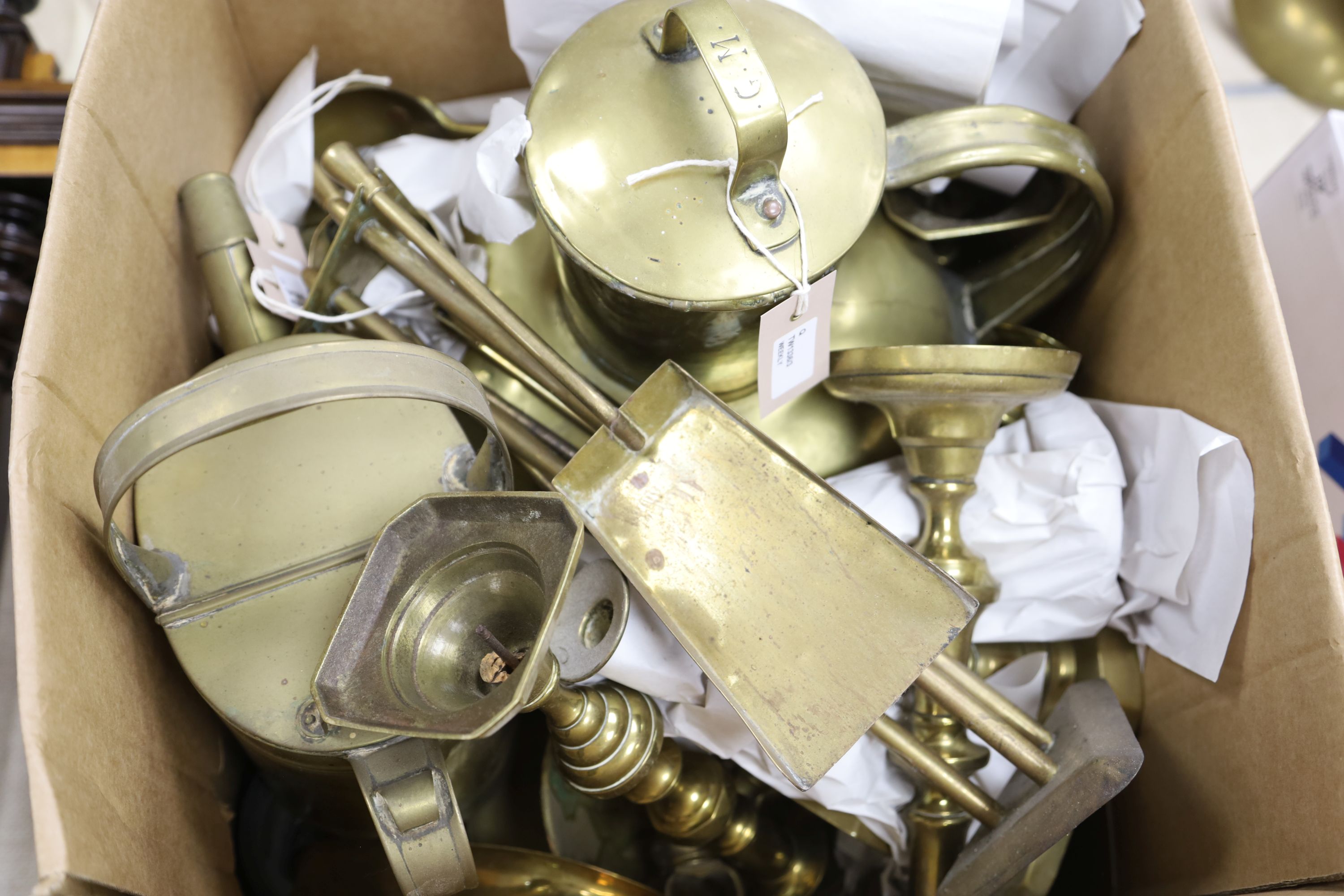 Collection of brass candlesticks, an Edwardian brass hot water jug, another brass jug and cover and a set of kitchen scales and weights